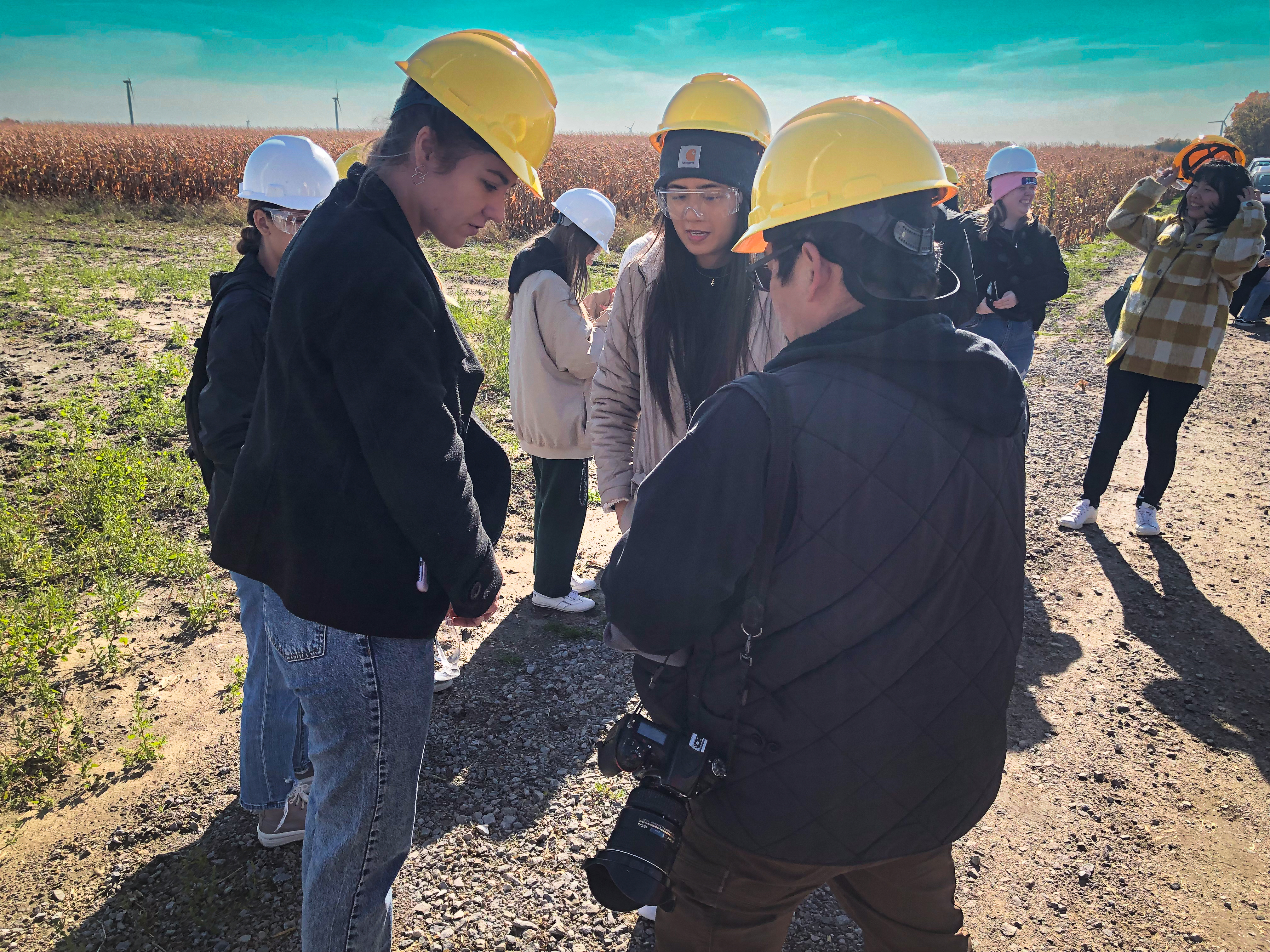 Three students in hardhats at a wind energy site_Photo credit Doug Bessette.jpg